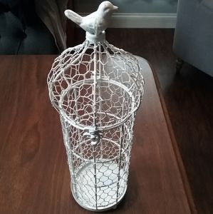 Birdcage bird on top